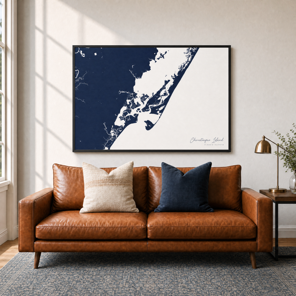 Chincoteague Island canvas map — two-pillow black-frame sofa interior