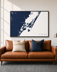 Chincoteague Island canvas map — two-pillow black-frame sofa interior