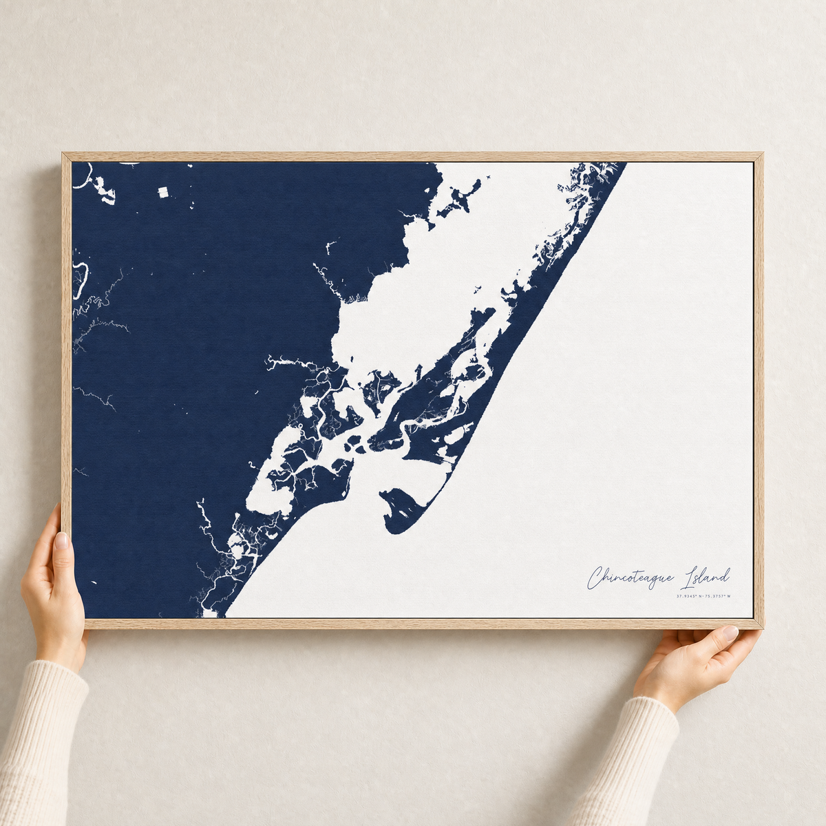Chincoteague Island canvas map — hands holding the canvas in an oak frame