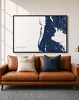 Clearwater Beach canvas map — two-pillow black-frame sofa interior