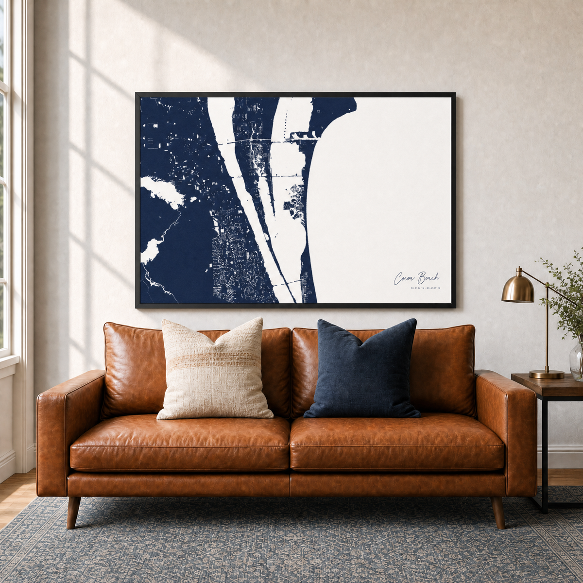 Cocoa Beach canvas map — two-pillow black-frame sofa interior