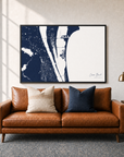 Cocoa Beach canvas map — two-pillow black-frame sofa interior