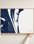 Cocoa Beach canvas map — hands holding the canvas in an oak frame
