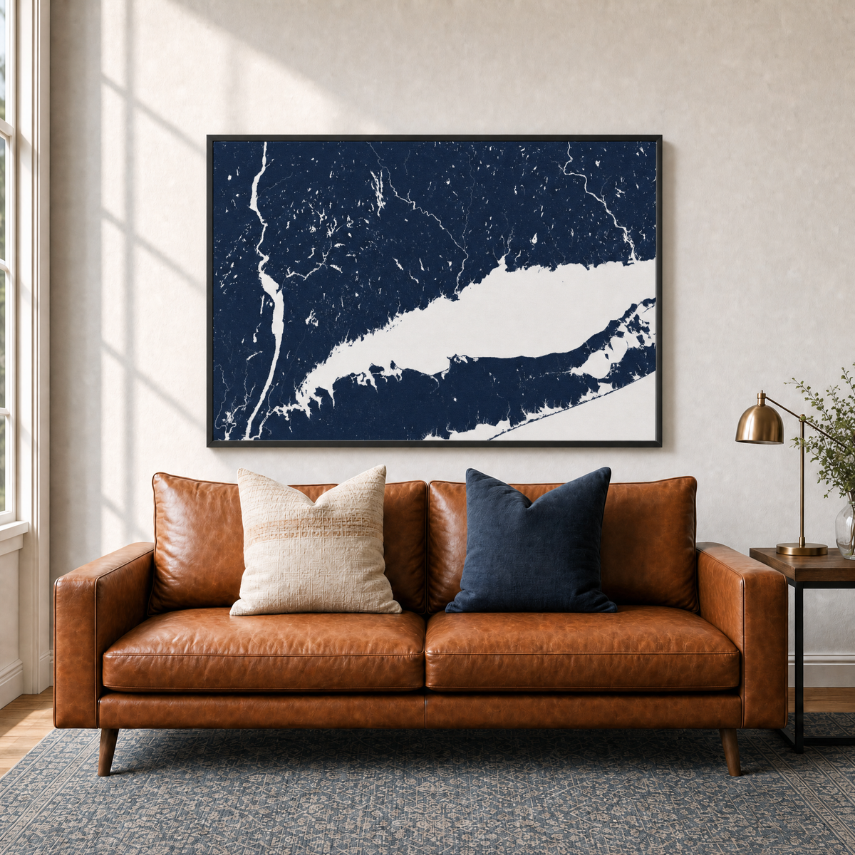 Connecticut Coast canvas map — two-pillow black-frame sofa interior