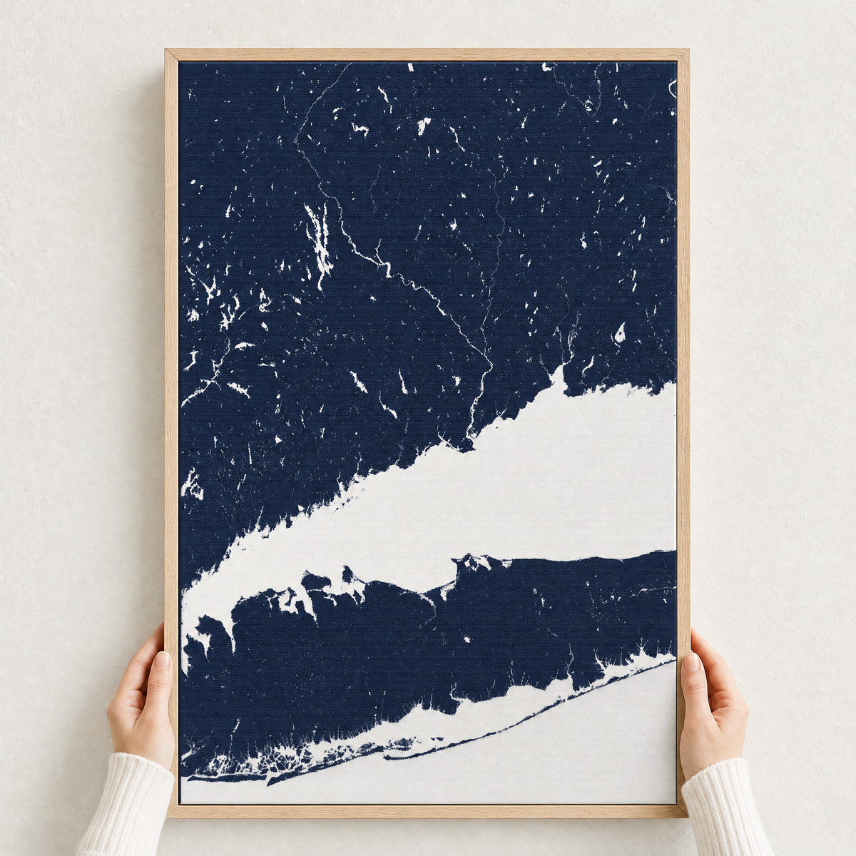 Connecticut Coast canvas map — hands holding the canvas in an oak frame