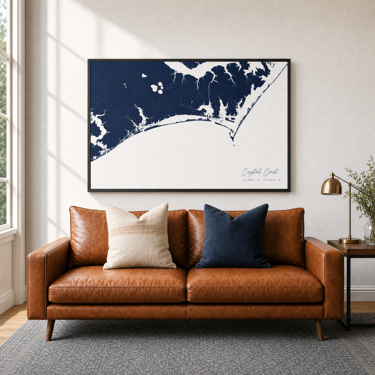 Crystal Coast / Emerald Isle canvas map — two-pillow black-frame sofa interior