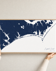 Crystal Coast / Emerald Isle canvas map — hands holding the canvas in an oak frame
