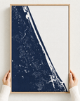 Daytona Beach canvas map — hands holding the canvas in an oak frame