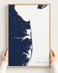 Delaware Beaches canvas map — hands holding the canvas in an oak frame