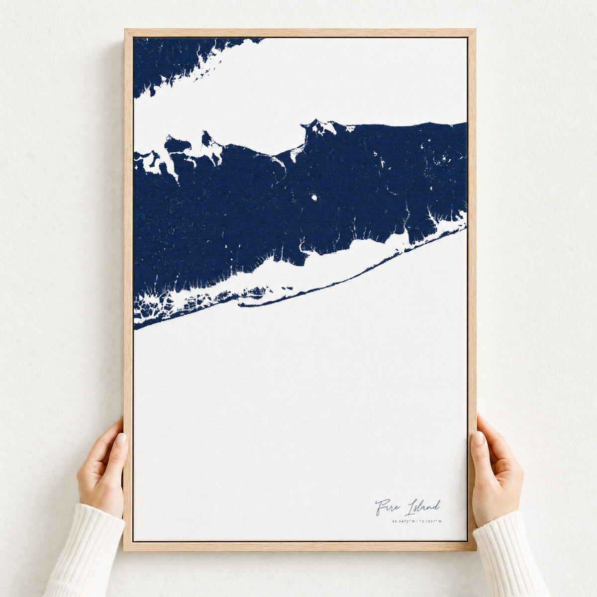 Fire Island canvas map — hands holding the canvas in an oak frame