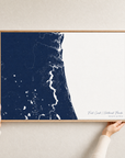 First Coast / Northeast Florida canvas map — hands holding the canvas in an oak frame