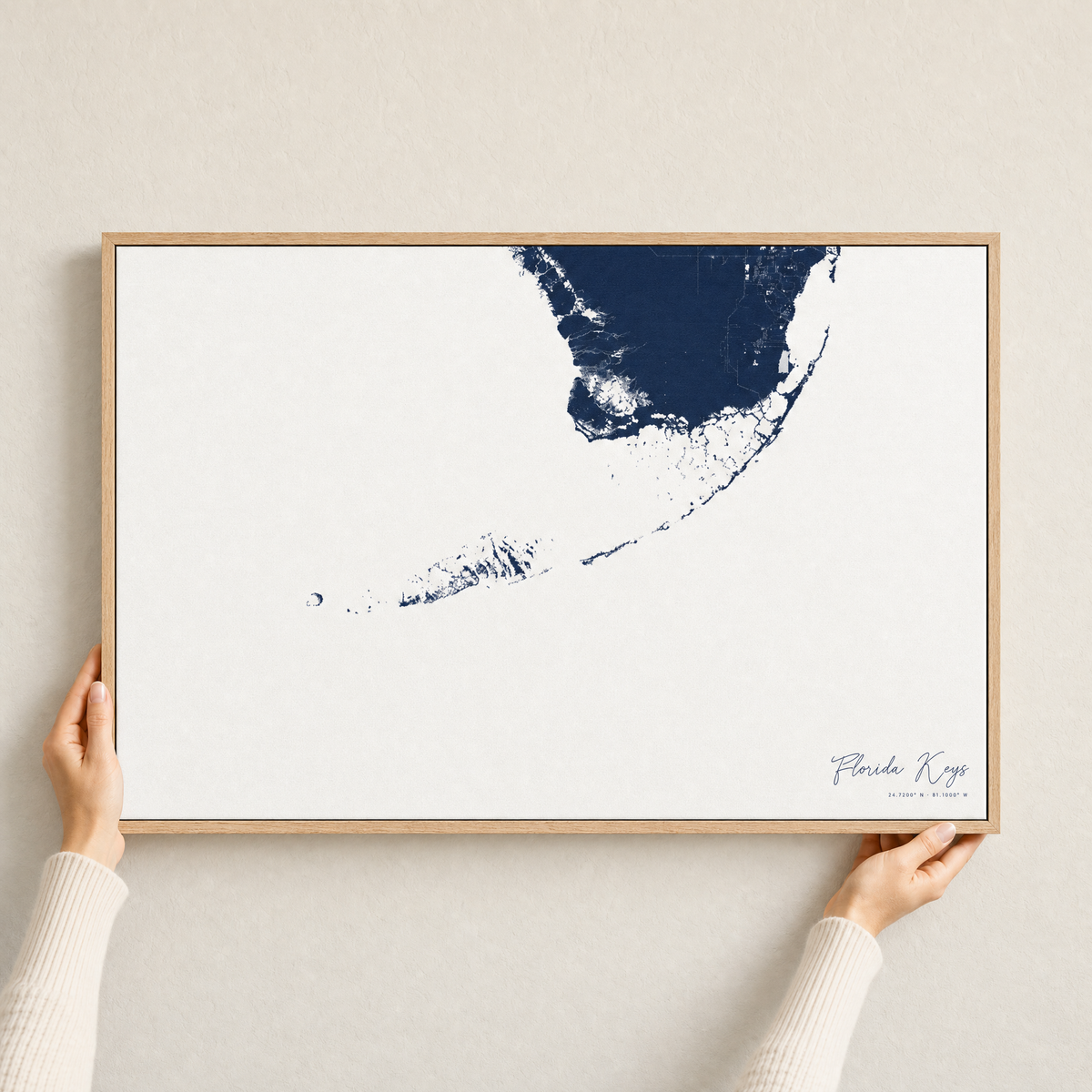 Florida Keys canvas map — hands holding the canvas in an oak frame