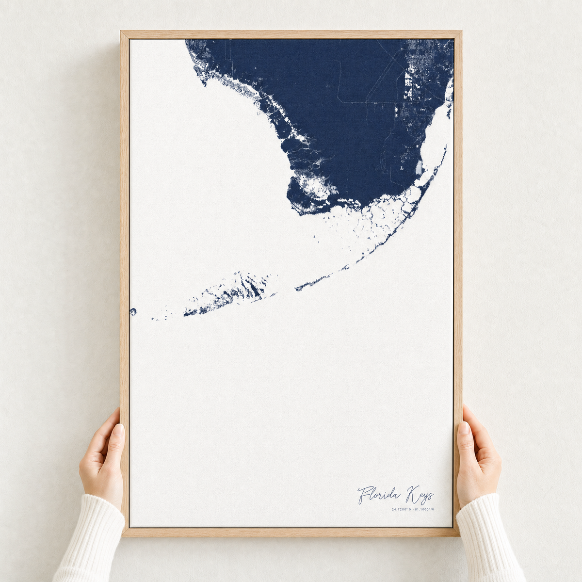 Florida Keys canvas map — hands holding the canvas in an oak frame