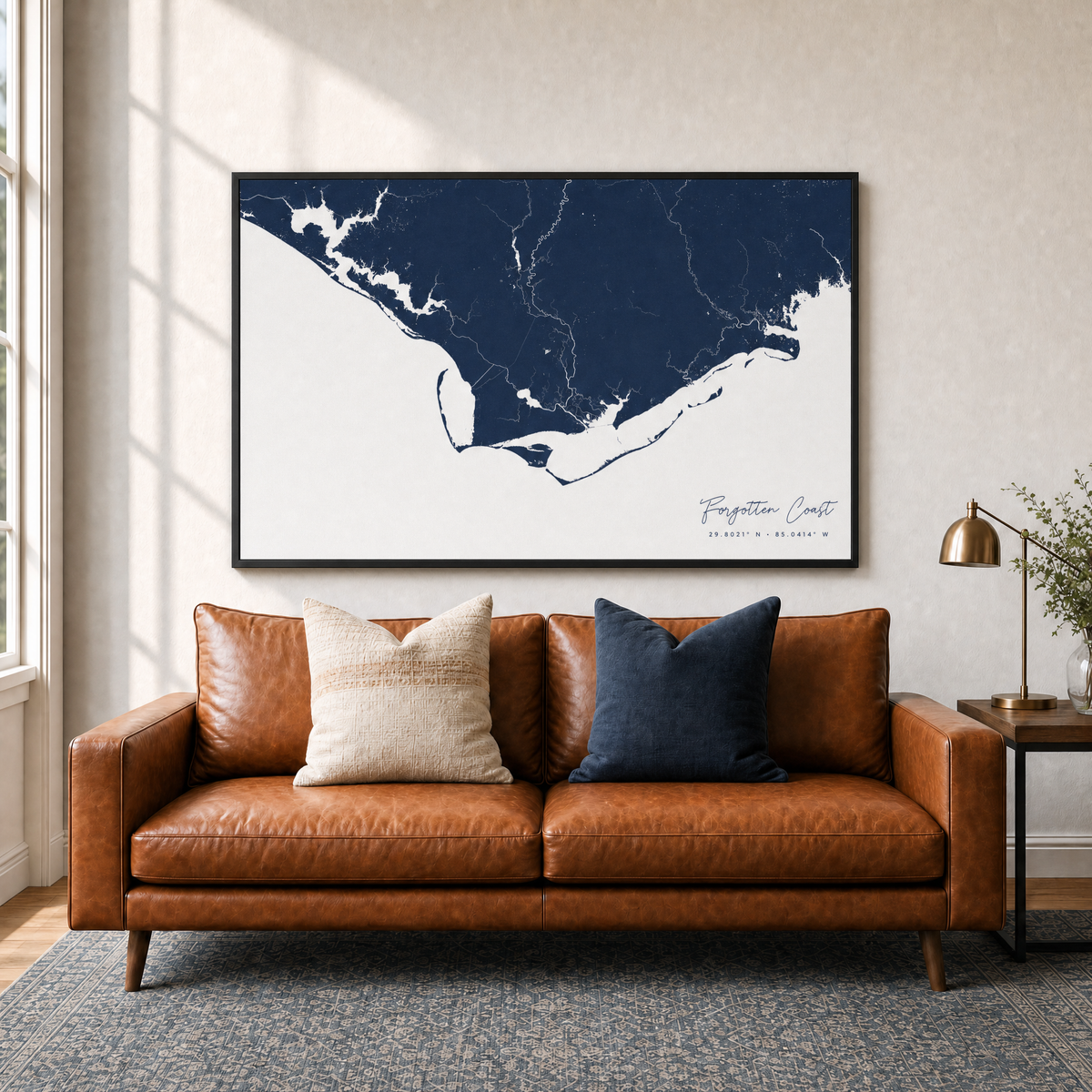 Forgotten Coast canvas map — two-pillow black-frame sofa interior
