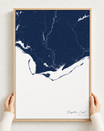 Forgotten Coast canvas map — hands holding the canvas in an oak frame