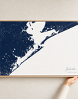 Galveston canvas map — hands holding the canvas in an oak frame