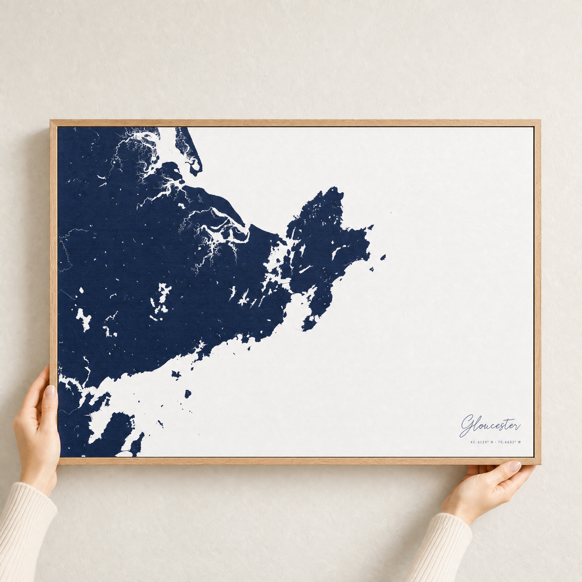 Gloucester canvas map — hands holding the canvas in an oak frame