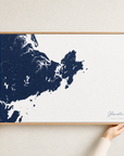 Gloucester canvas map — hands holding the canvas in an oak frame