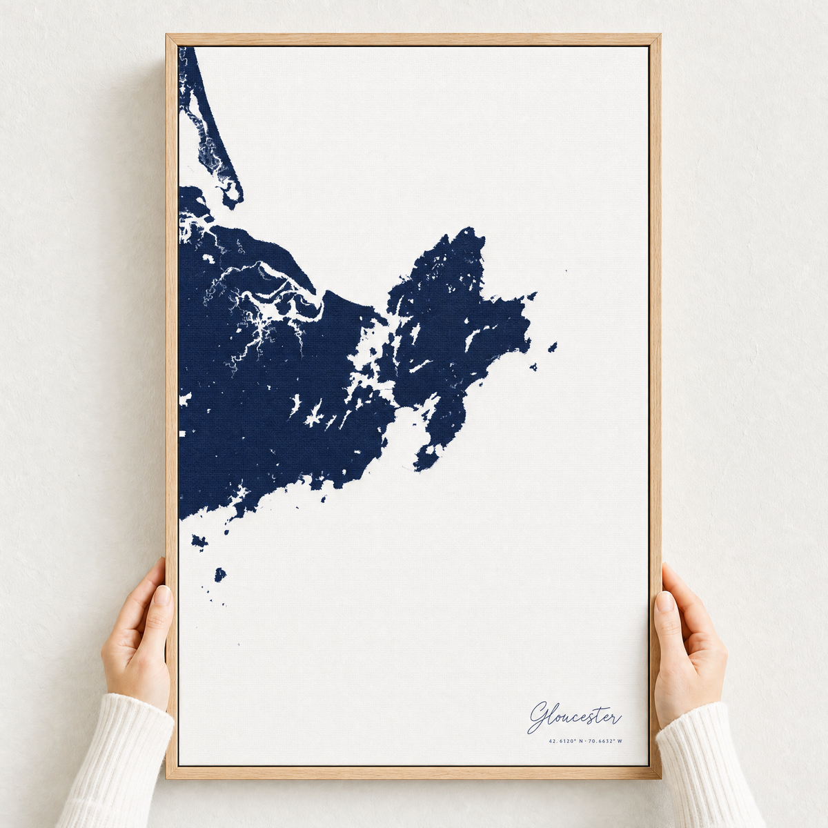 Gloucester canvas map — hands holding the canvas in an oak frame