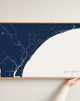 Grand Strand canvas map — hands holding the canvas in an oak frame