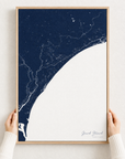 Grand Strand canvas map — hands holding the canvas in an oak frame