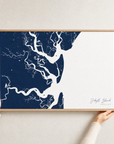 Jekyll Island canvas map — hands holding the canvas in an oak frame