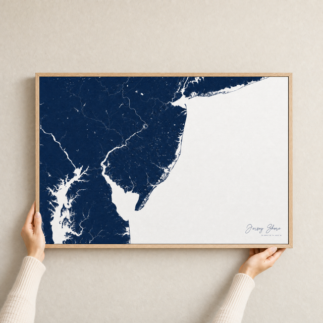 Jersey Shore canvas map — hands holding the canvas in an oak frame