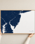 Jersey Shore canvas map — hands holding the canvas in an oak frame