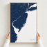 Jersey Shore canvas map — hands holding the canvas in an oak frame