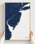 Jersey Shore canvas map — hands holding the canvas in an oak frame