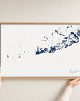 Key West canvas map — hands holding the canvas in an oak frame