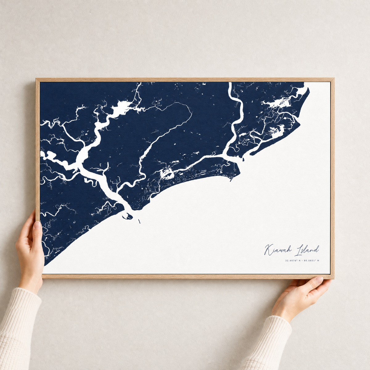 Kiawah Island canvas map — hands holding the canvas in an oak frame