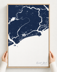 Kiawah Island canvas map — hands holding the canvas in an oak frame