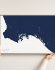 Long Beach canvas map — hands holding the canvas in an oak frame