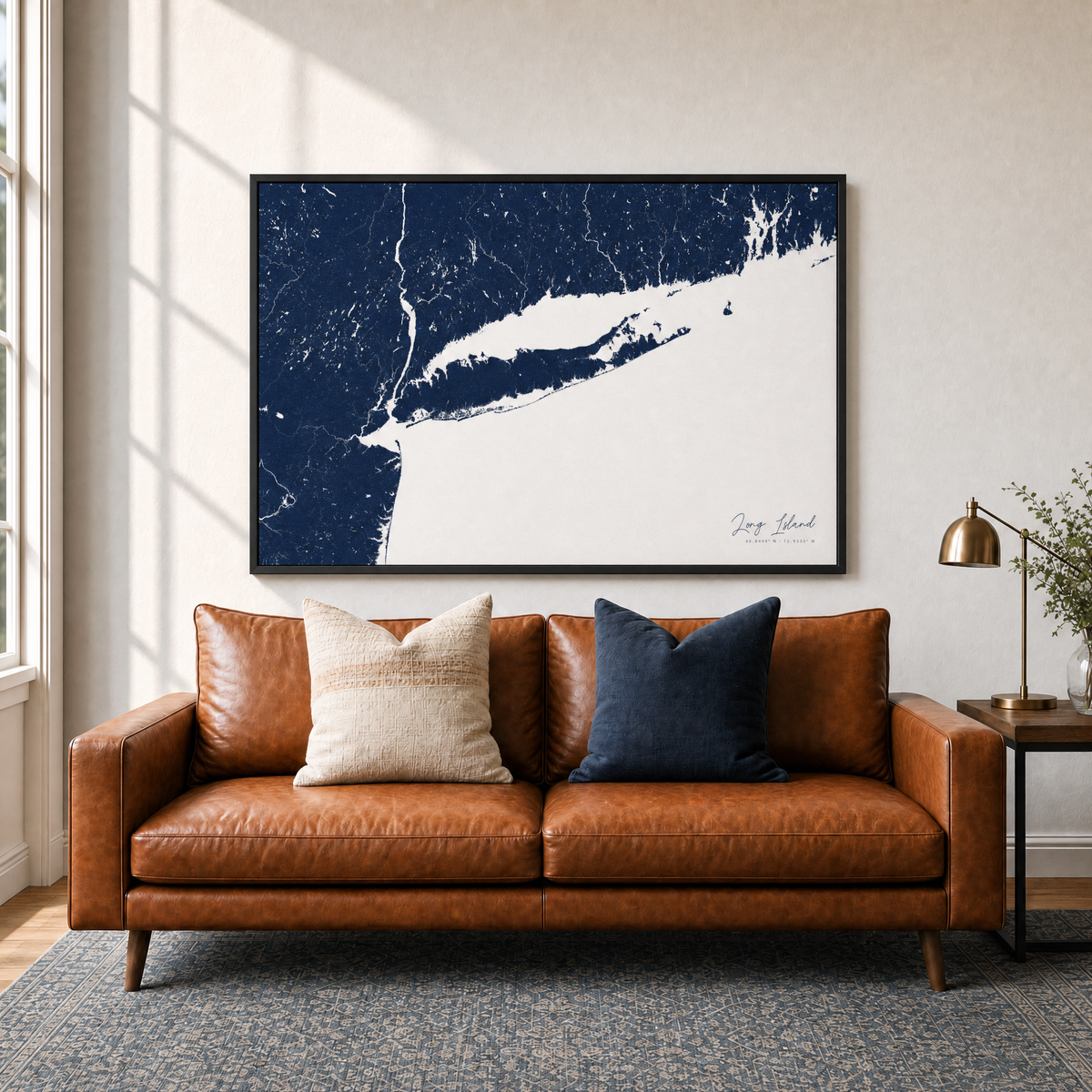 Long Island canvas map — two-pillow black-frame sofa interior