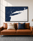 Long Island canvas map — two-pillow black-frame sofa interior