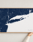 Long Island canvas map — hands holding the canvas in an oak frame