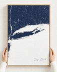 Long Island canvas map — hands holding the canvas in an oak frame