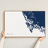Marco Island canvas map — hands holding the canvas in an oak frame