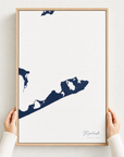 Montauk canvas map — hands holding the canvas in an oak frame