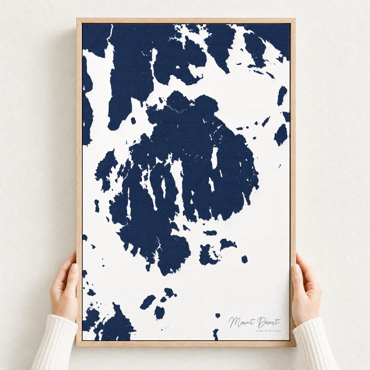 Mount Desert canvas map — hands holding the canvas in an oak frame