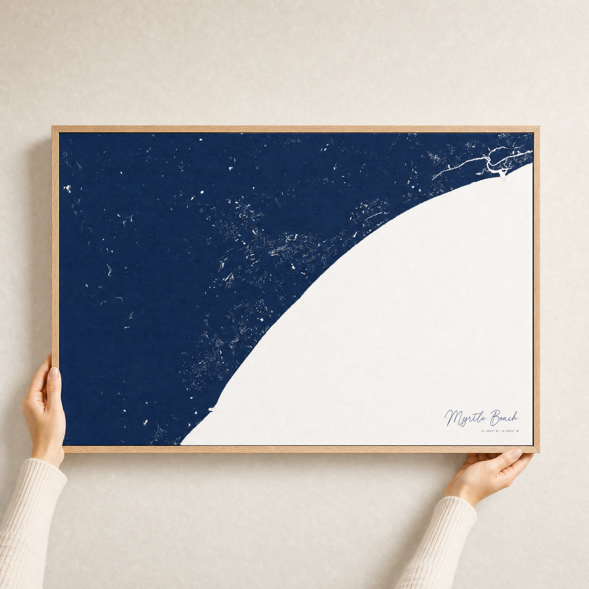 Myrtle Beach canvas map — hands holding the canvas in an oak frame