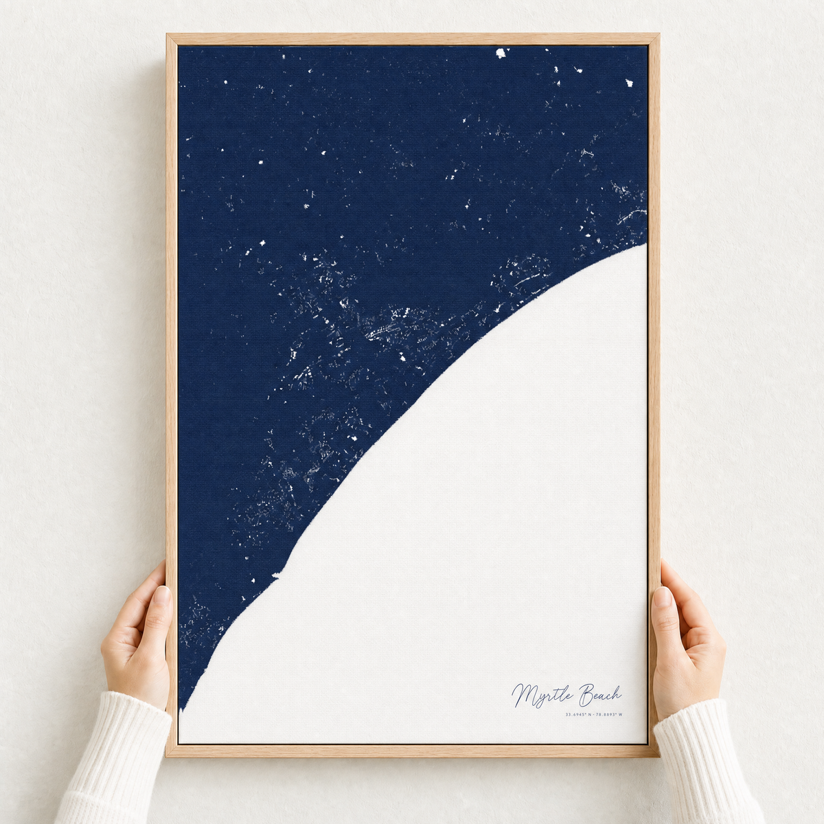 Myrtle Beach canvas map — hands holding the canvas in an oak frame