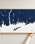 Mystic canvas map — hands holding the canvas in an oak frame
