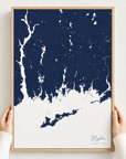 Mystic canvas map — hands holding the canvas in an oak frame