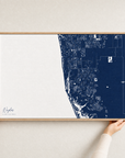 Naples canvas map — hands holding the canvas in an oak frame