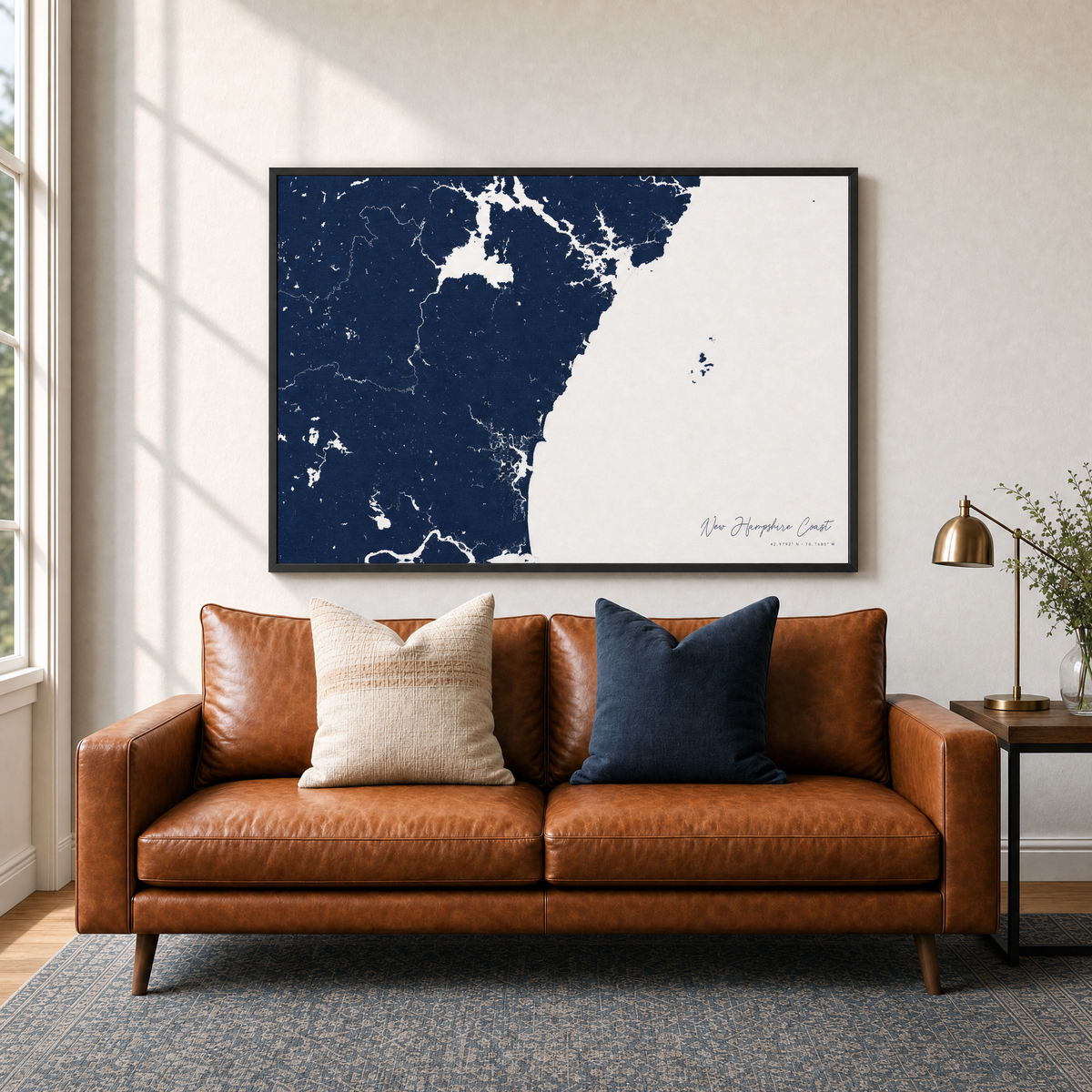 New Hampshire Coast canvas map — two-pillow black-frame sofa interior