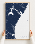 New Hampshire Coast canvas map — hands holding the canvas in an oak frame