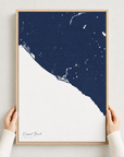 Newport Beach canvas map — hands holding the canvas in an oak frame
