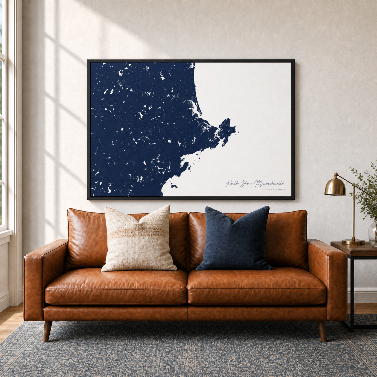 North Shore Massachusetts canvas map — two-pillow black-frame sofa interior